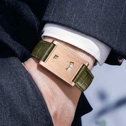 Rose gold watch with green strap on a person's wrist, wearing a dark suit and white shirt.